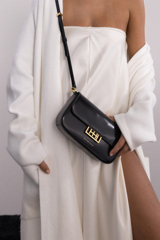 The Jolie Leather Baguette Mini Bag in Black/Gold on Model 3